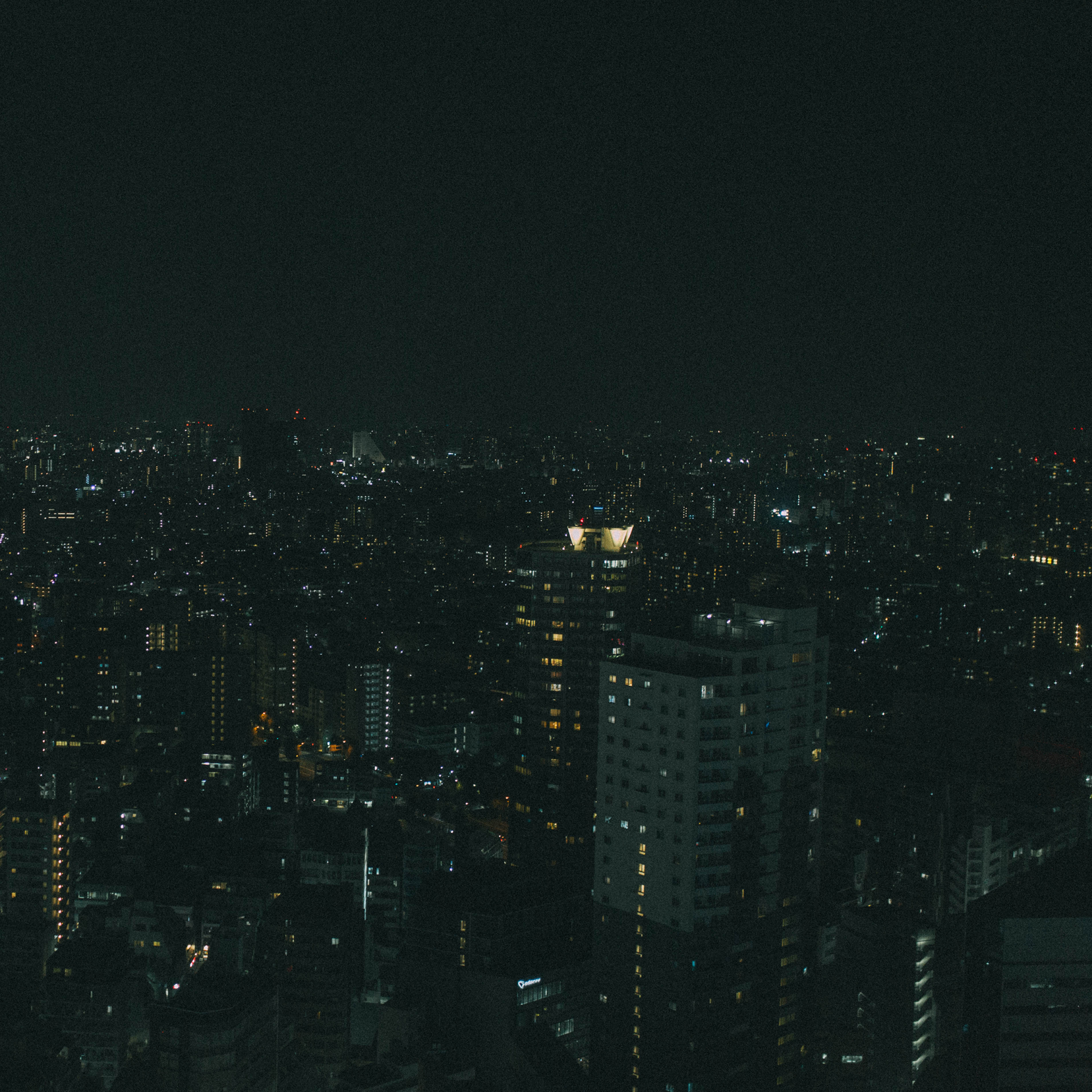 view of tokyo skyline from a room at the groove hotel, with city lights and buildings stretching into the distance